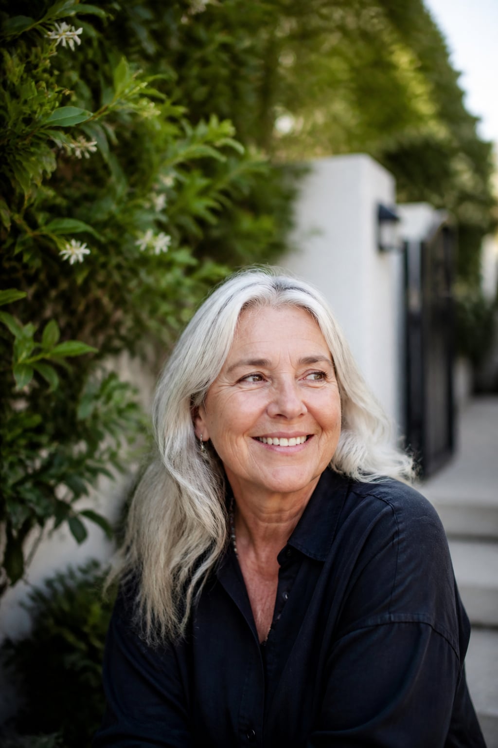 An older adult smiling confidently in natural light.