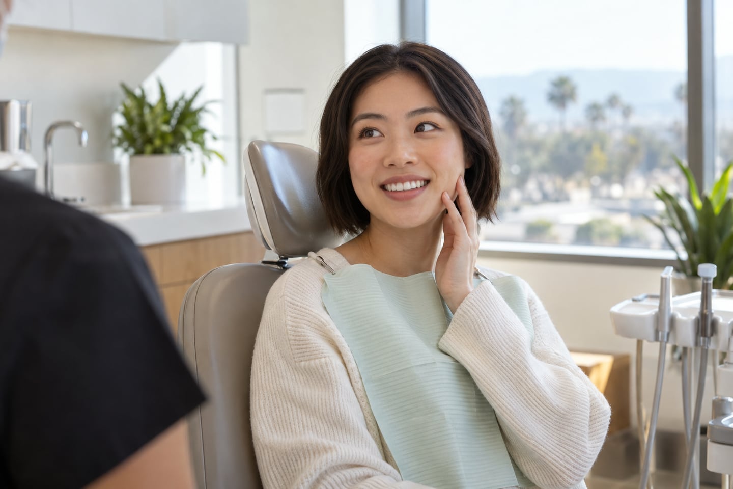 A patient touching their cheek after an appointment while the numbness wears off.